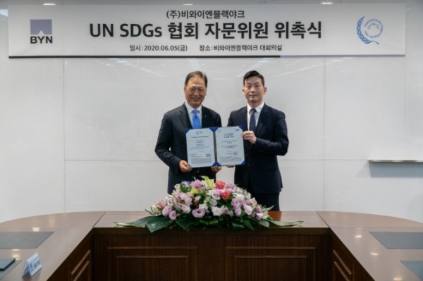 강태선 비와이엔블랙야크 회장(사진 왼쪽)과 김정훈 UN SDGs 협회 대표가 기념촬영을 하고 있다. 사진=비와이엔블랙야크 제공