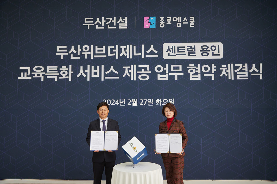 오세욱 두산건설 상무(왼쪽)와 성영남 종로엠스쿨 대표가 기념 촬영하고 있다. 사진=두산건설