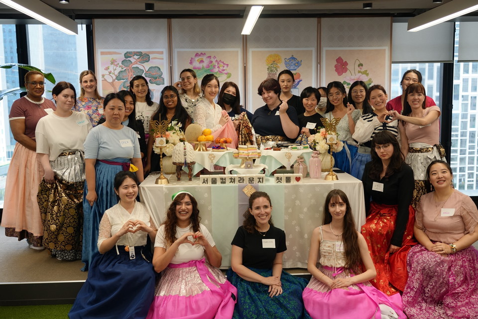 외국인 참가자들이 서울컬쳐라운지 첫돌을 맞아 돌상과 책가도 병풍 앞에서 단체사진을 촬영하고 있다. 사진=서울관광재단