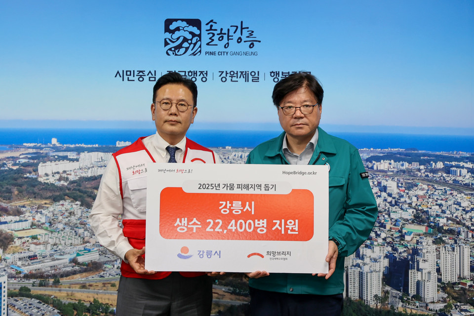 전국재해구호협회 신훈 사무총장(왼쪽)과 강릉시 김동율 행정국장이 3일 오후 강릉시청에서 가뭄 극복을 위한 생수 전달식 사진을 찍고 있다. 사진=희망브리지